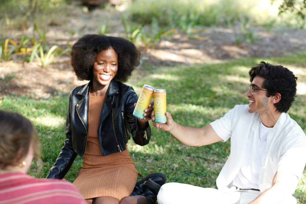 Two people cheersing seltzer