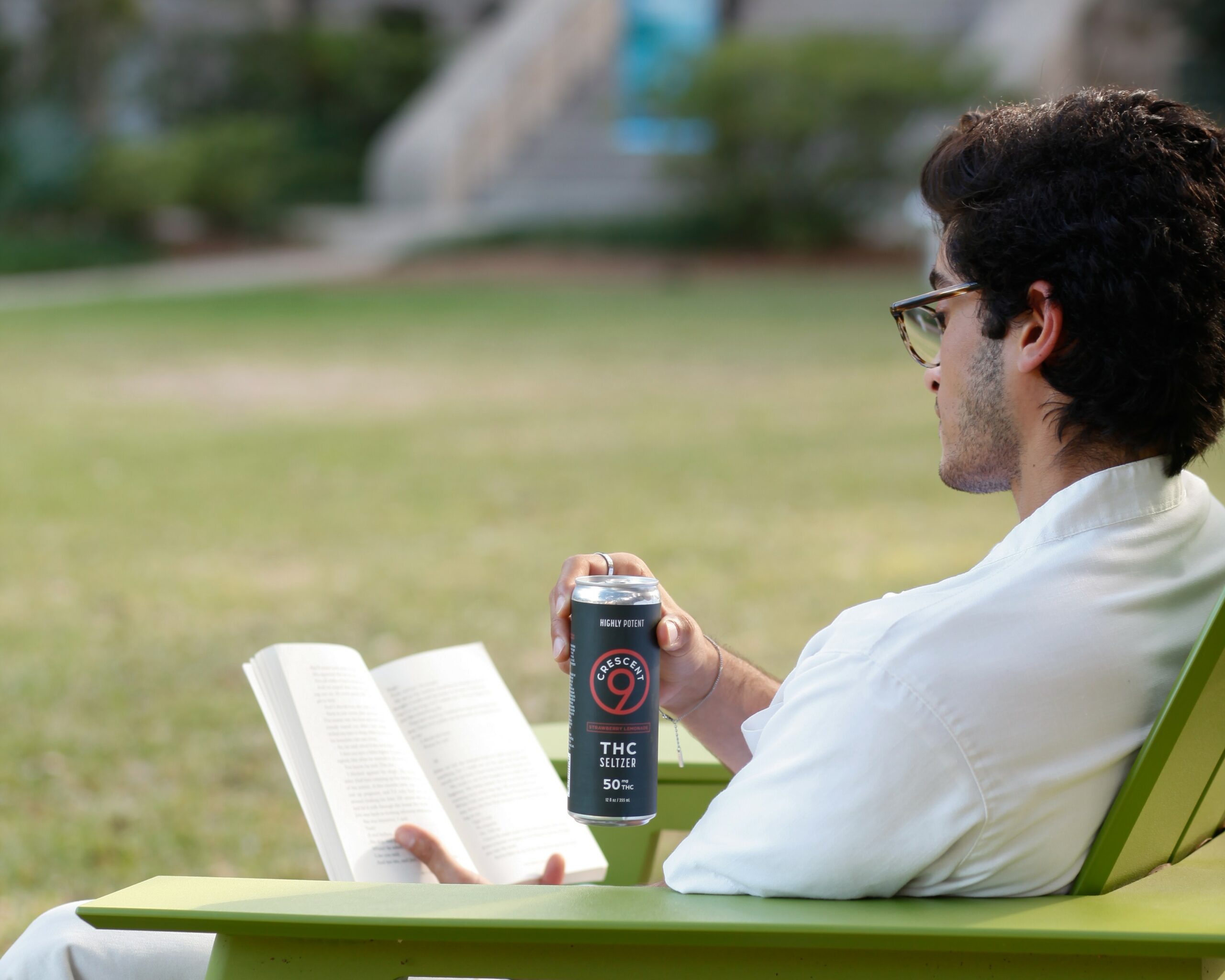 Man reading while drinking high-potency THC seltzer