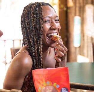 A woman eating a THC edible cereal bar