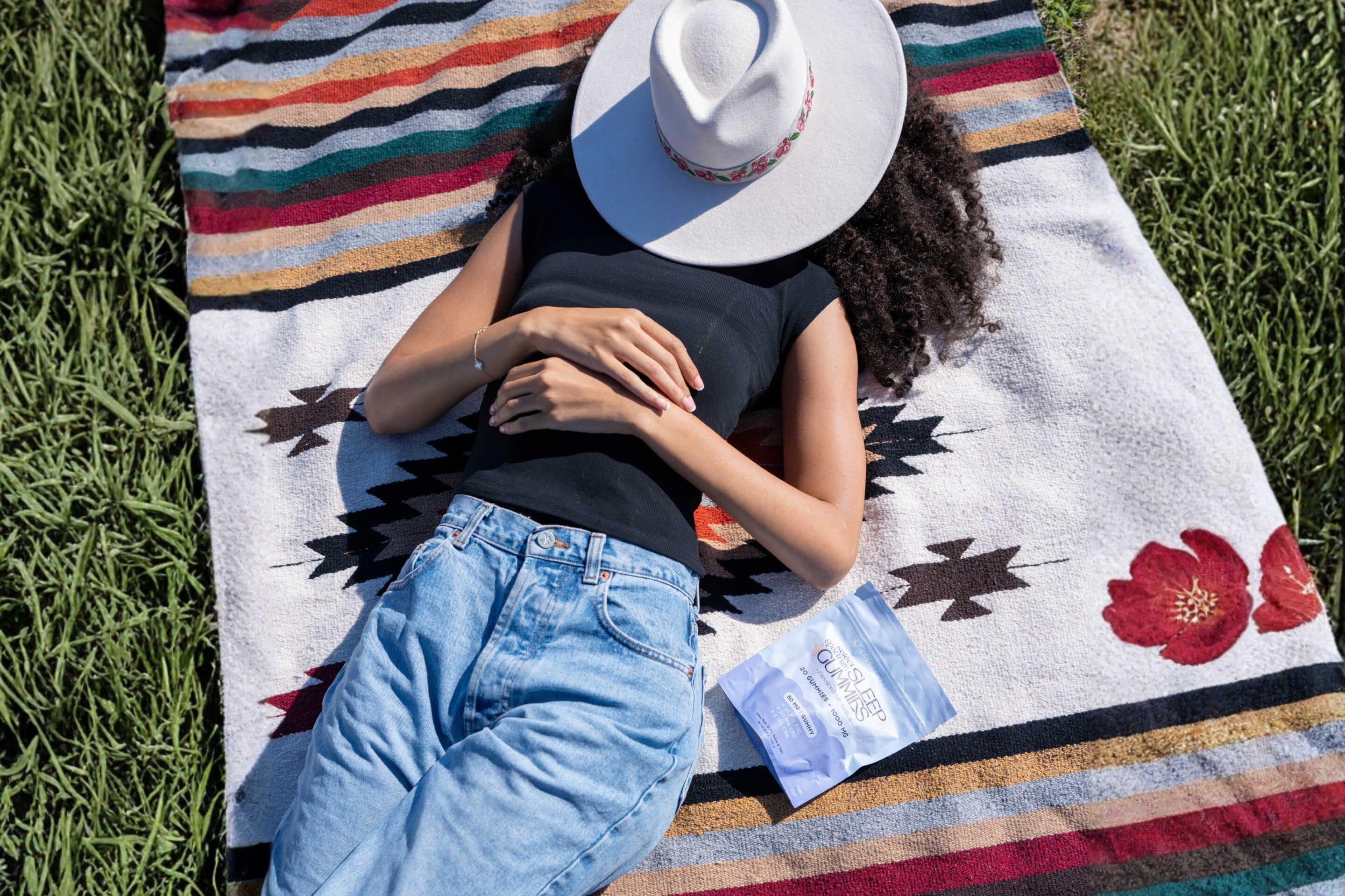Women sleeping next to THC Sleep Gummies